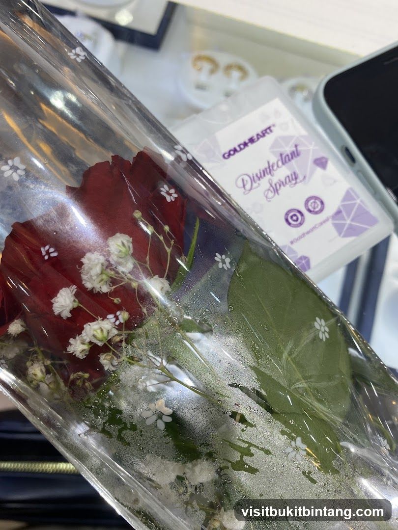 Red rose with baby's breath and disinfectant spray