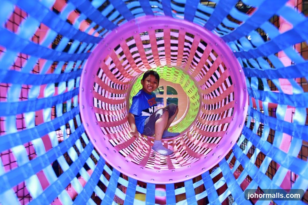 Child in a colorful play tunnel