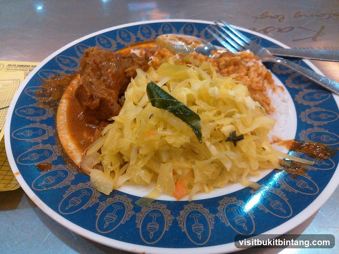 Plate of food with meat, rice, and cabbage