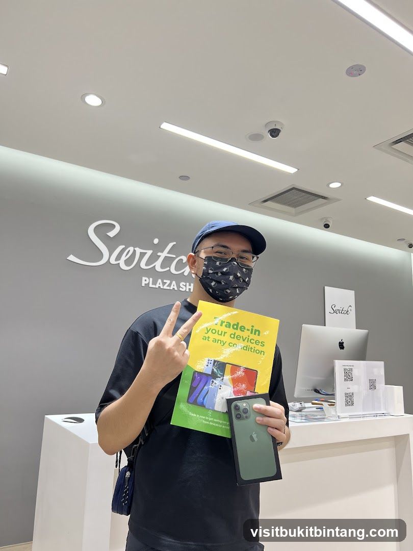 Man holding a new iPhone and a promotional flyer