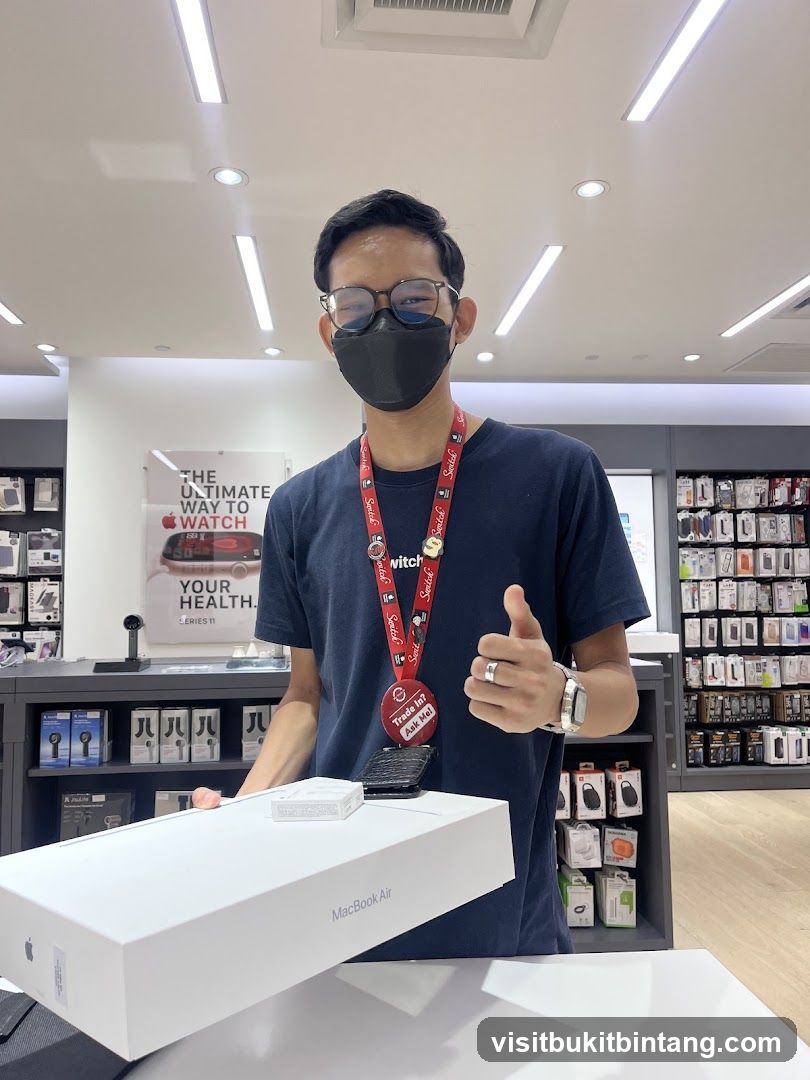 Salesperson with MacBook Air Box