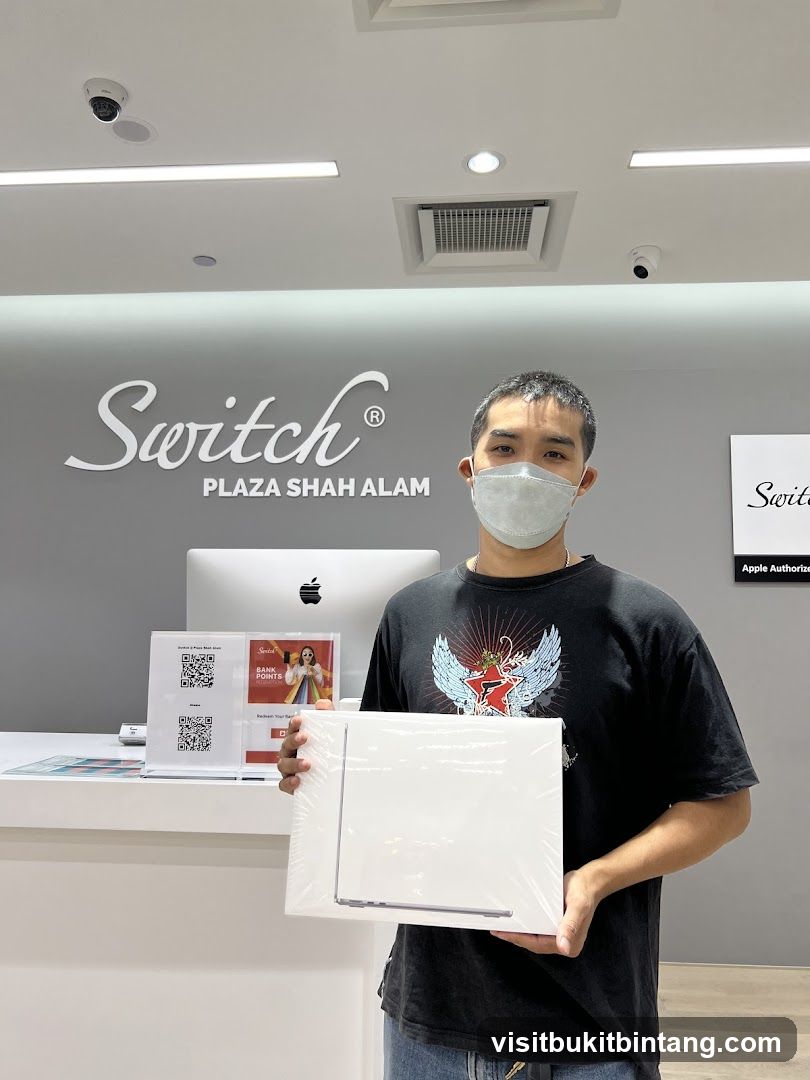 Man holding a laptop in a store