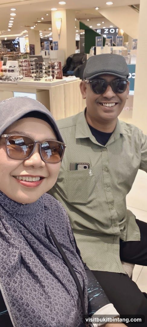 Couple trying on sunglasses