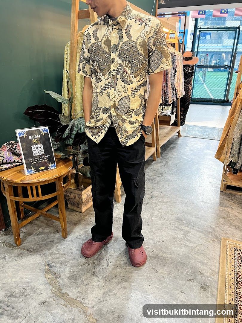 Man in patterned shirt and black pants