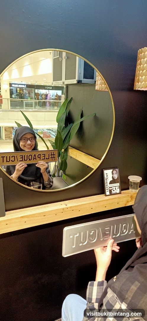 Woman holding a sign in front of a mirror