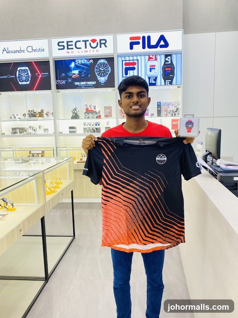 Man holding a t-shirt and a smartwatch box in a store