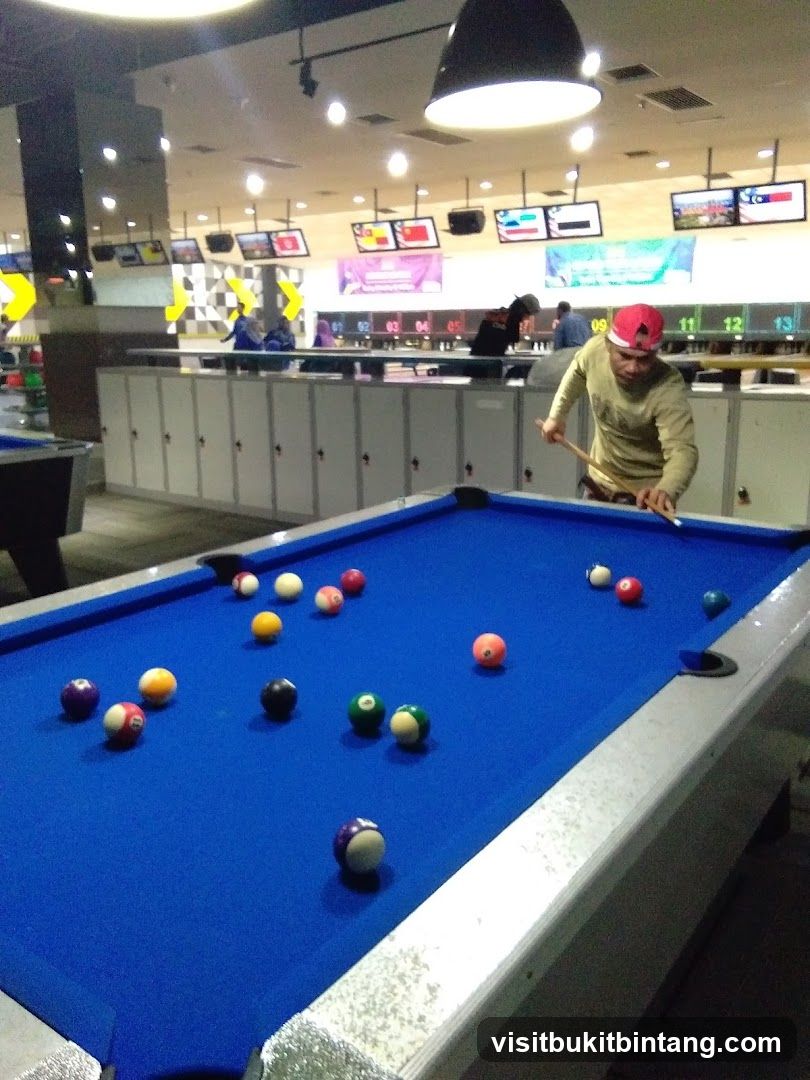 People playing pool in a bowling alley