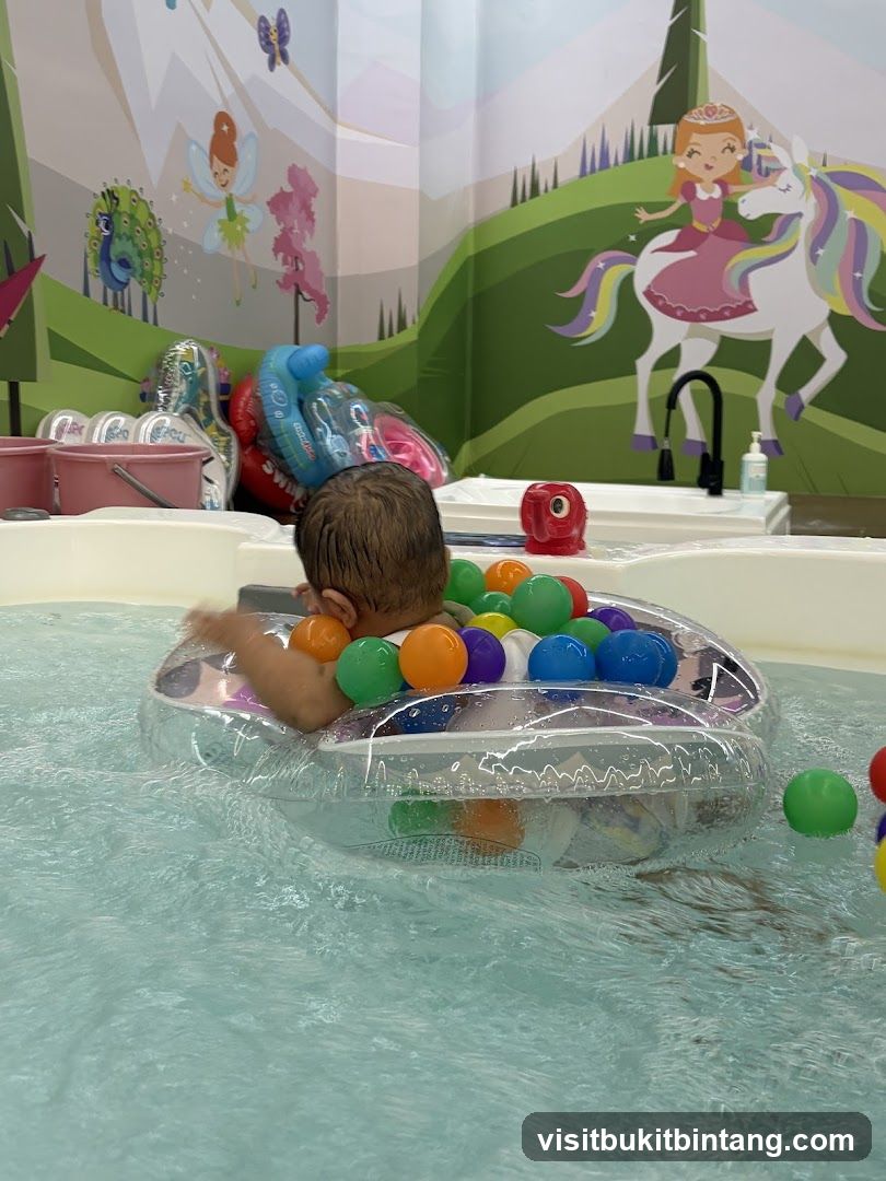 Baby in a pool with colorful balls