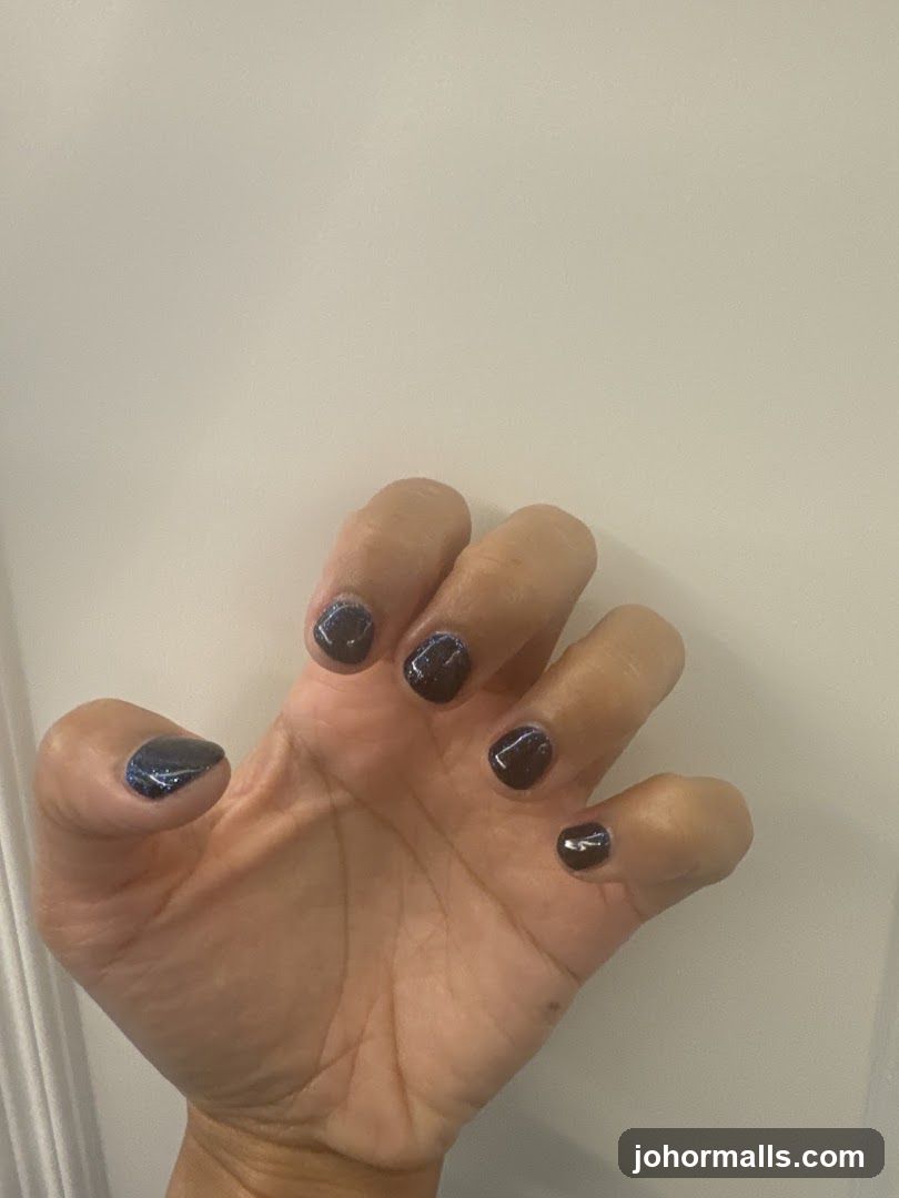 Hand with Dark Glitter Nail Polish