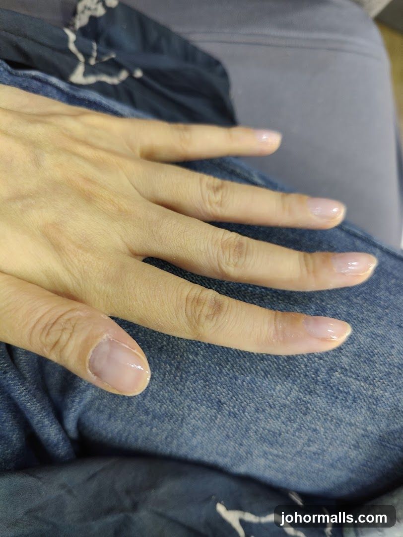 Hand with light pink nails