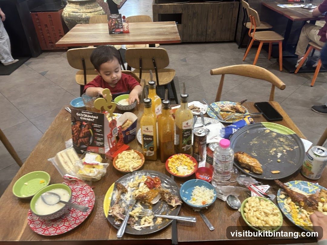 Messy Table with Food and a Child