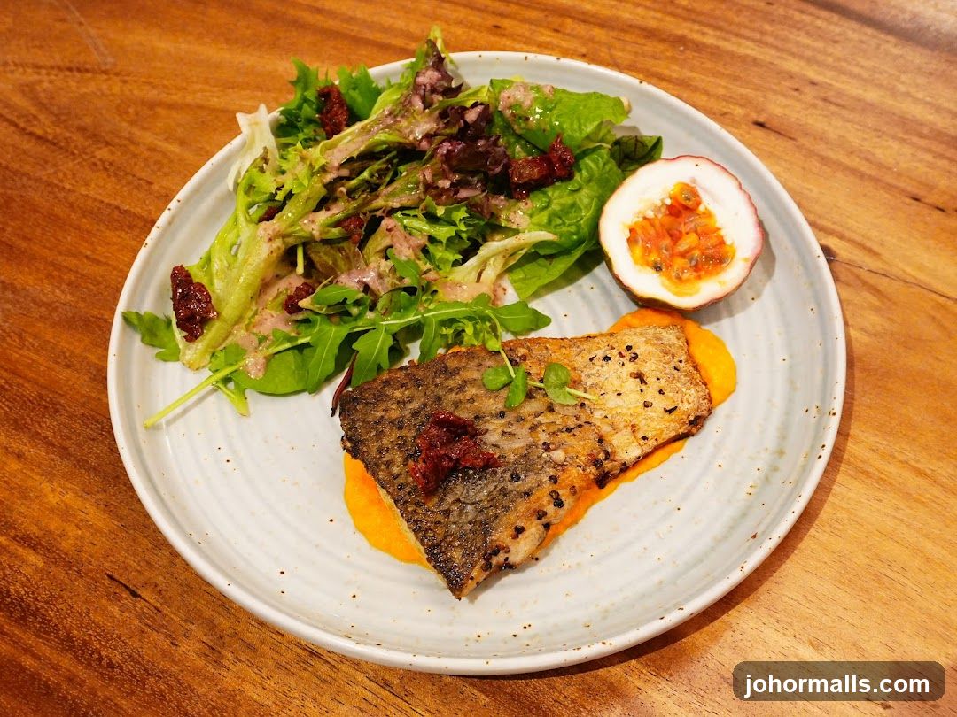 Fish dish with salad and passion fruit