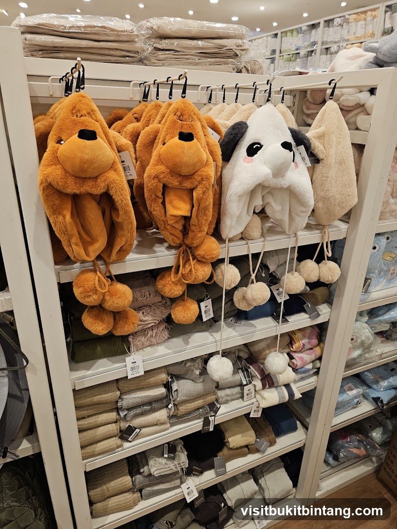 Animal-themed hats and folded textiles on display shelves