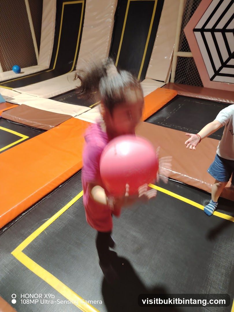 Children playing dodgeball on trampolines