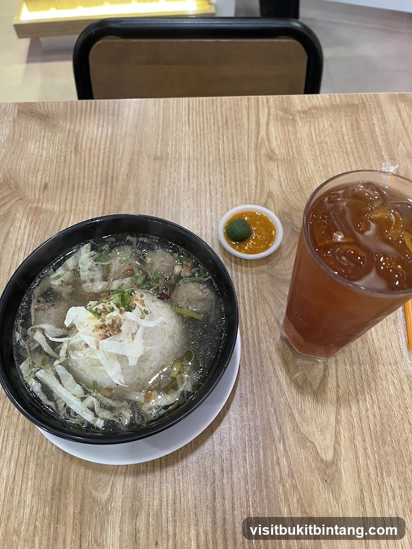 Bowl of Rice Soup with Meatballs and Iced Tea