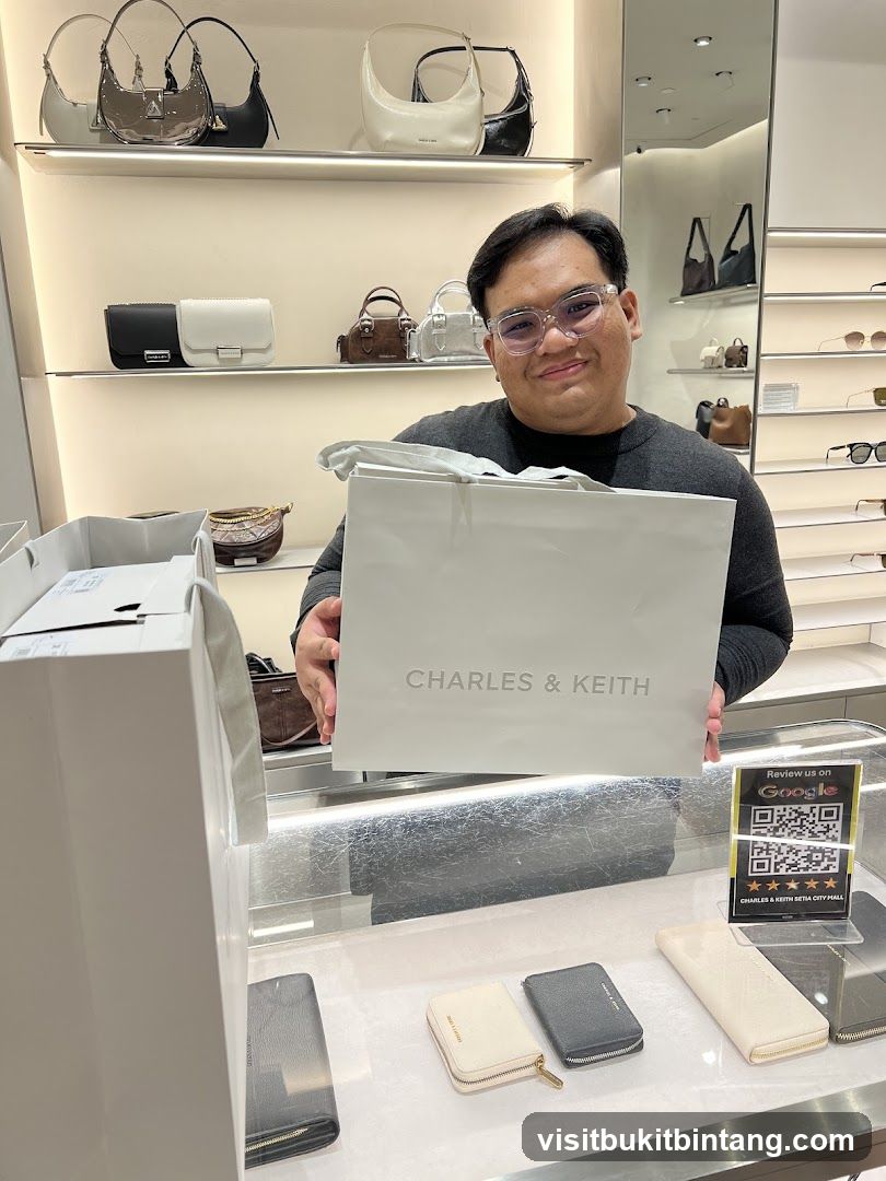 Man holding a Charles & Keith shopping bag