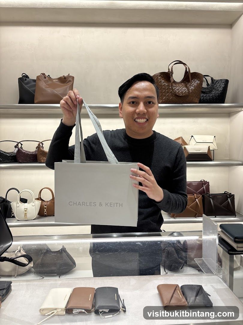 Man holding a Charles & Keith shopping bag