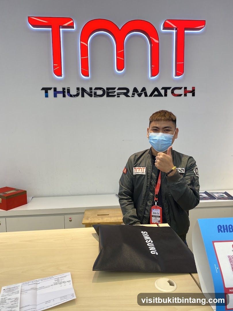 Man giving thumbs up in front of TMT Thunder Match sign