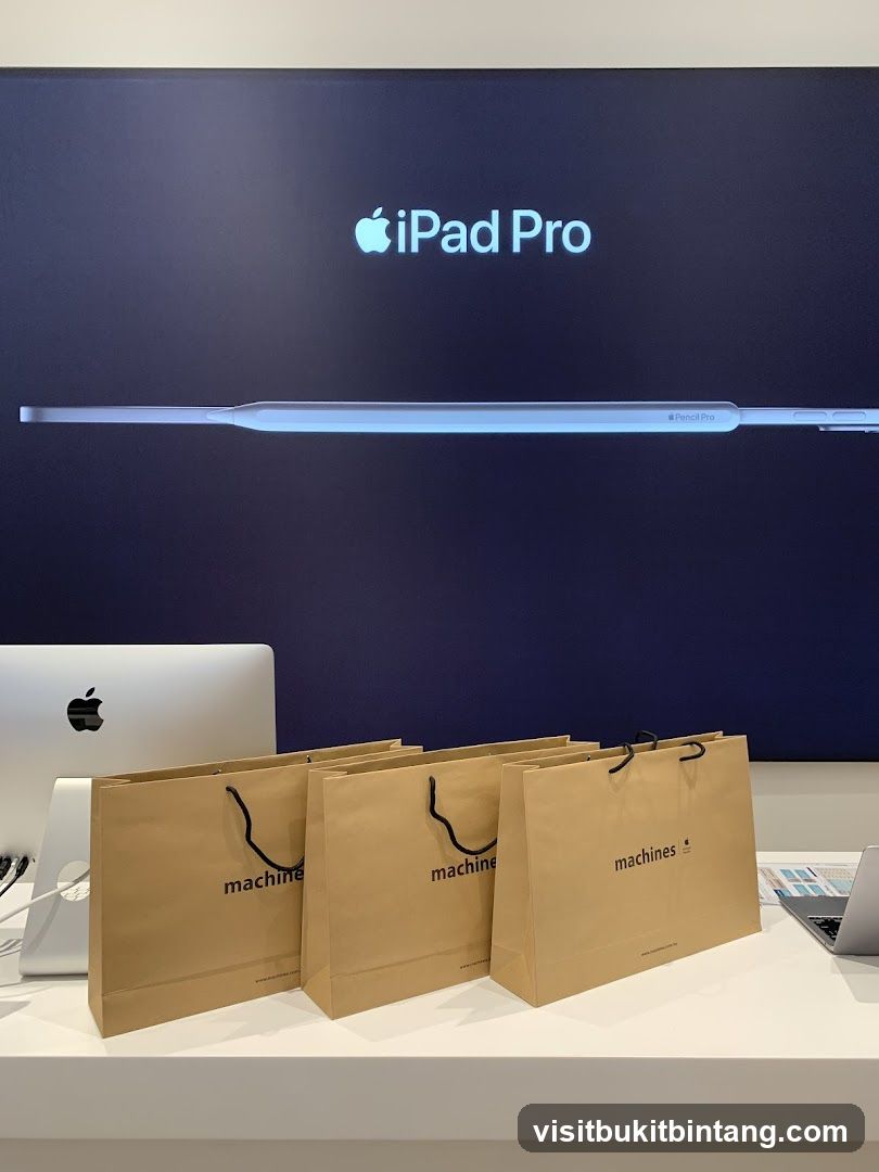Apple iPad Pro and Pencil Pro display with branded shopping bags