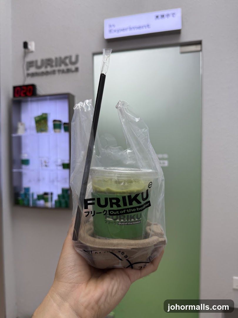 Person holding a matcha drink from Furiku