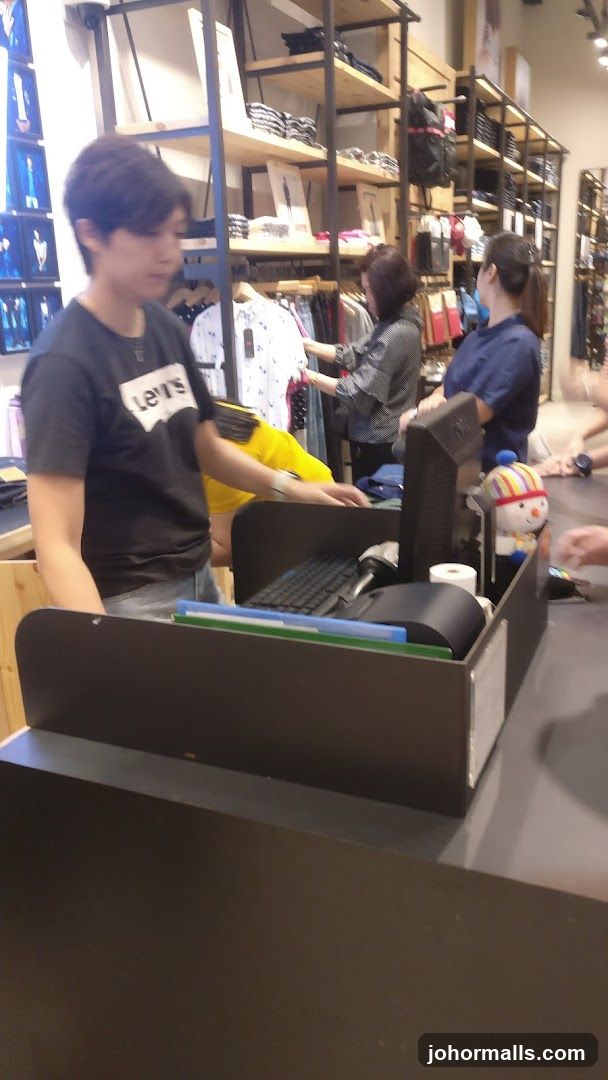 Retail store interior with shoppers and cashier