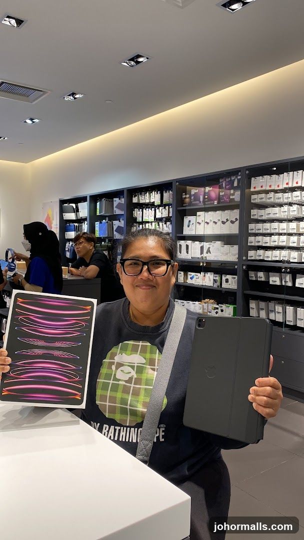 Woman holding an iPad and its box