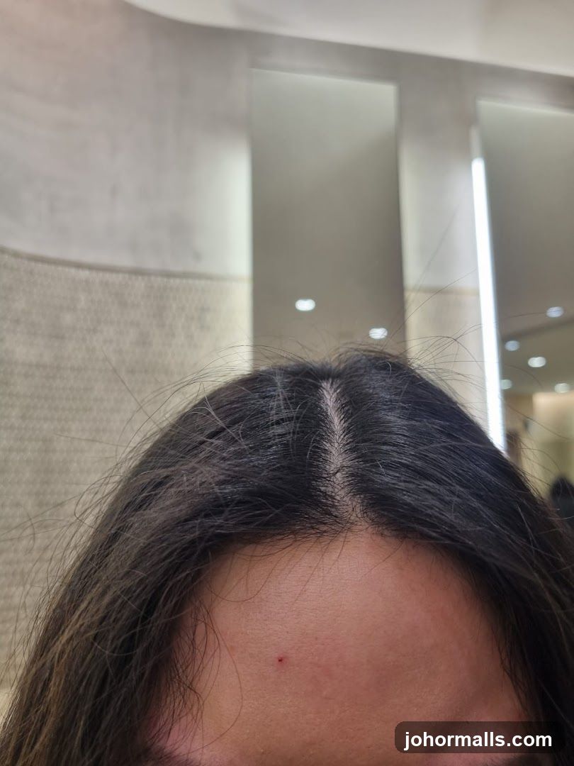 Close-up of a person's forehead and hair