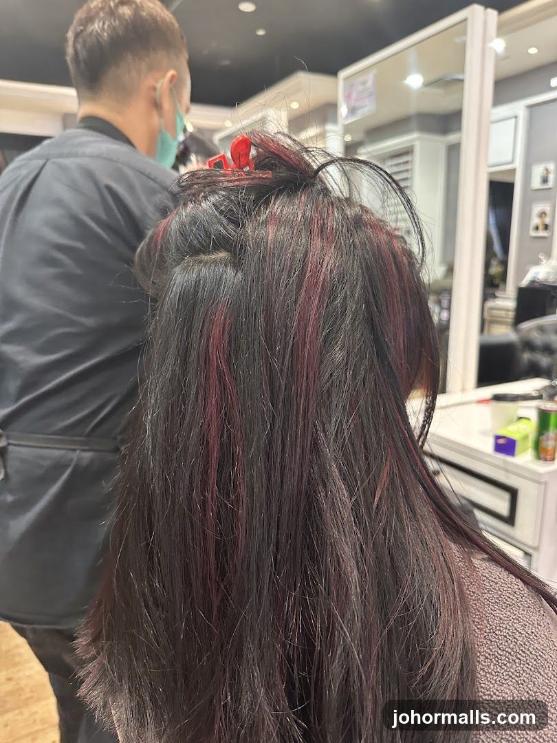 Hairdresser working on client's hair