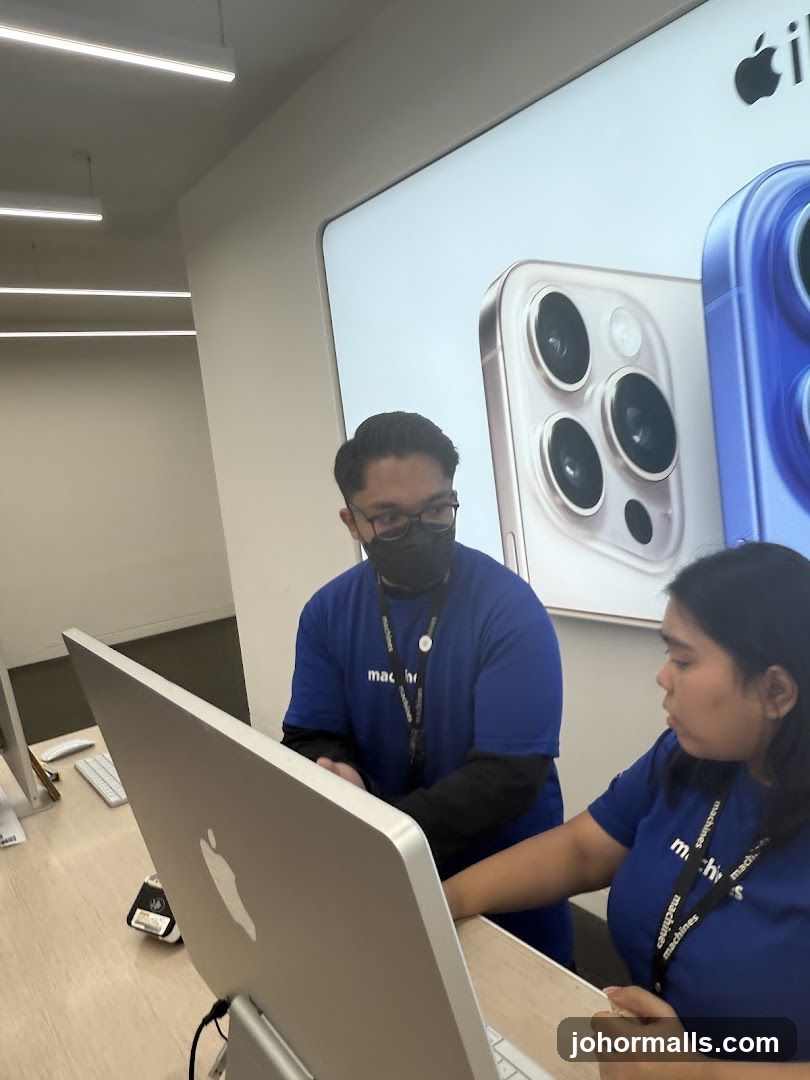 Employees assisting customer at Apple store