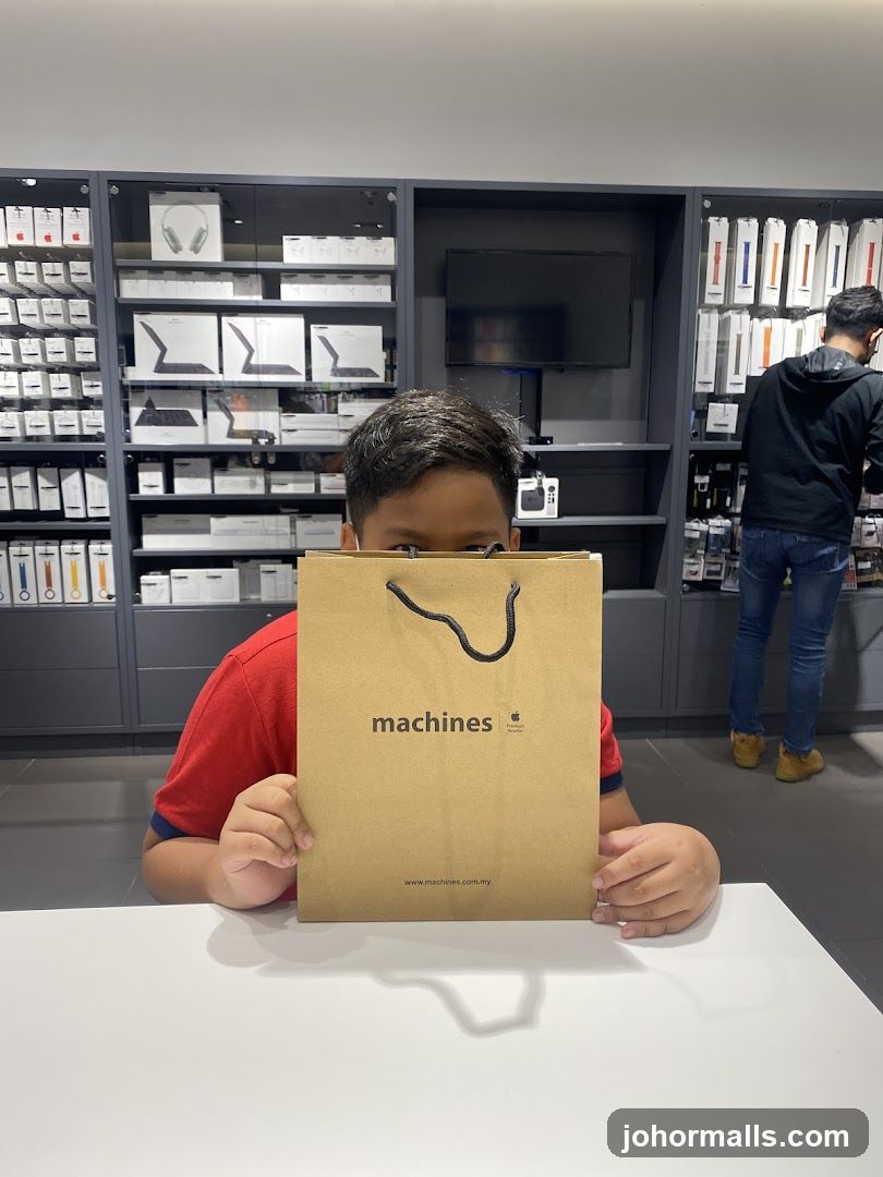 Boy holding a shopping bag in a store