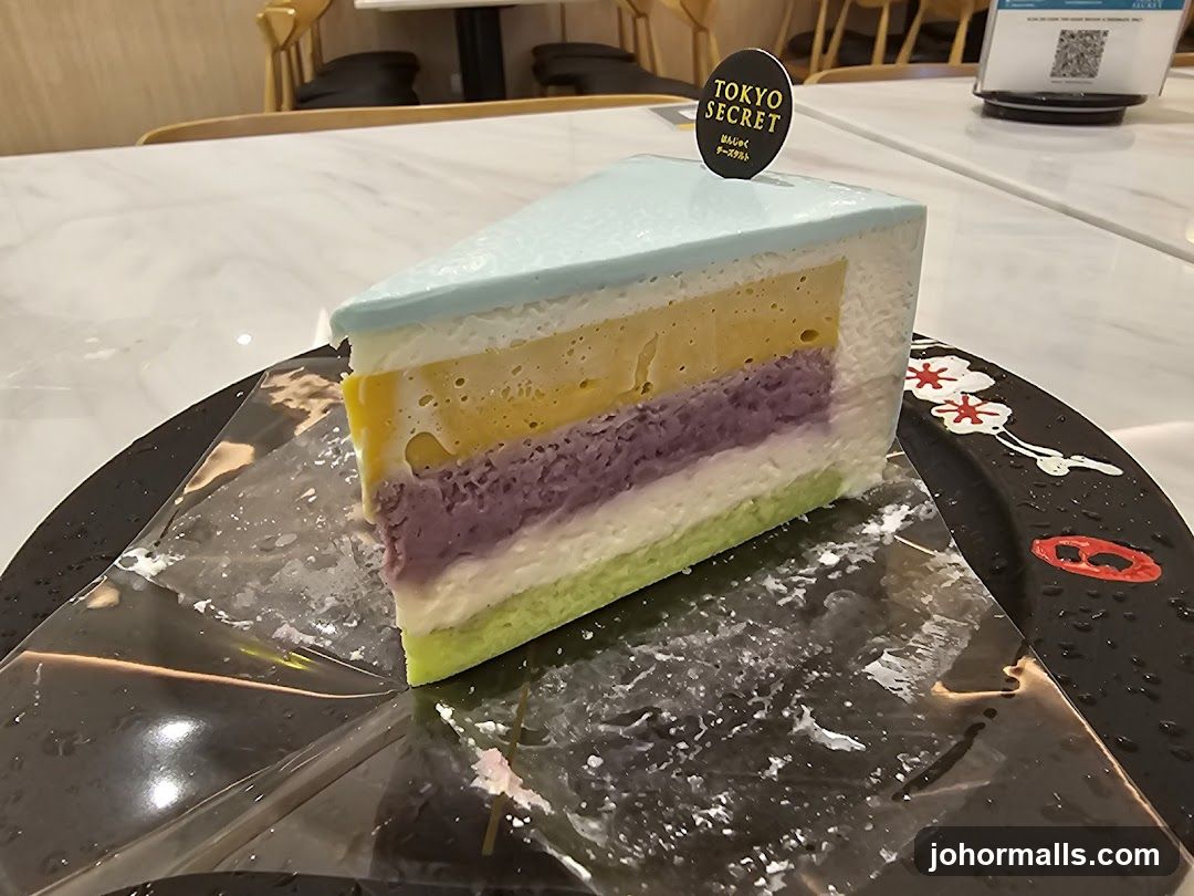 Slice of layered cake with 'Tokyo Secret' sign