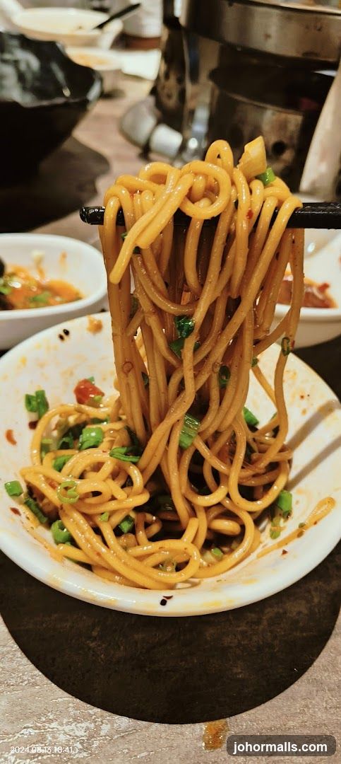 Noodles being lifted with chopsticks