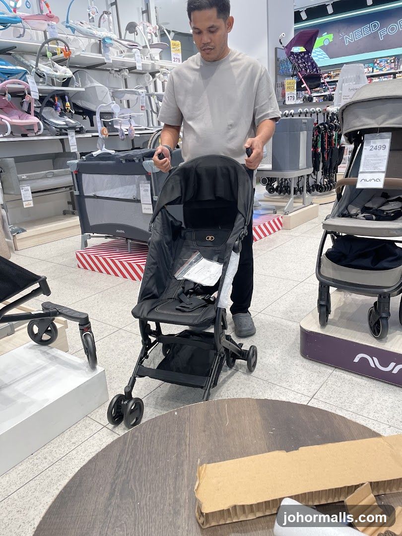 Man examining a stroller in a store