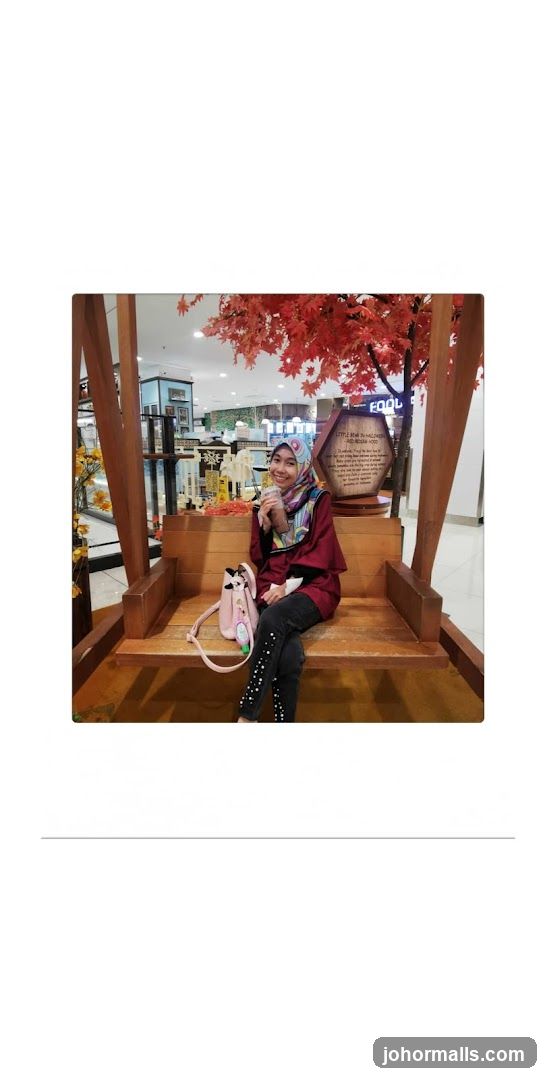 Woman sitting on a wooden swing with autumn decorations