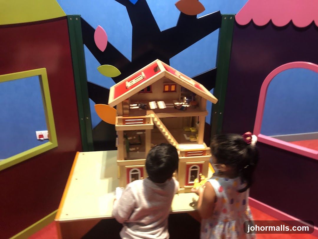 Children playing with a dollhouse