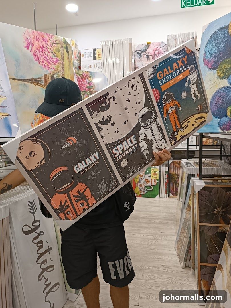 Person holding a framed artwork