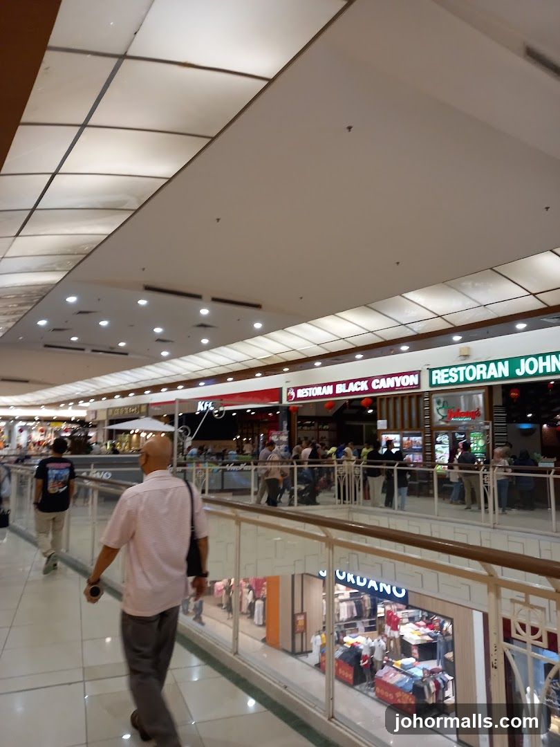 Indoor shopping mall with various stores and restaurants