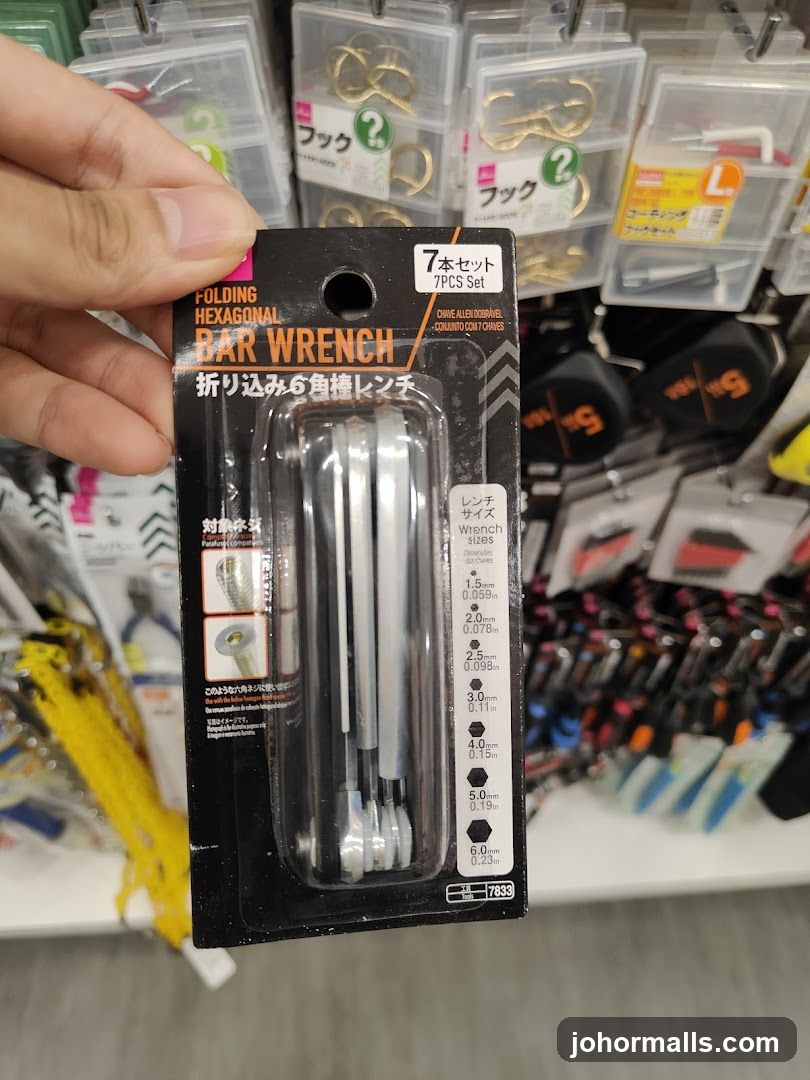 Hand holding a folding hexagonal bar wrench set