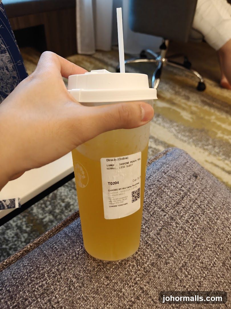 Hand holding beverage cup
