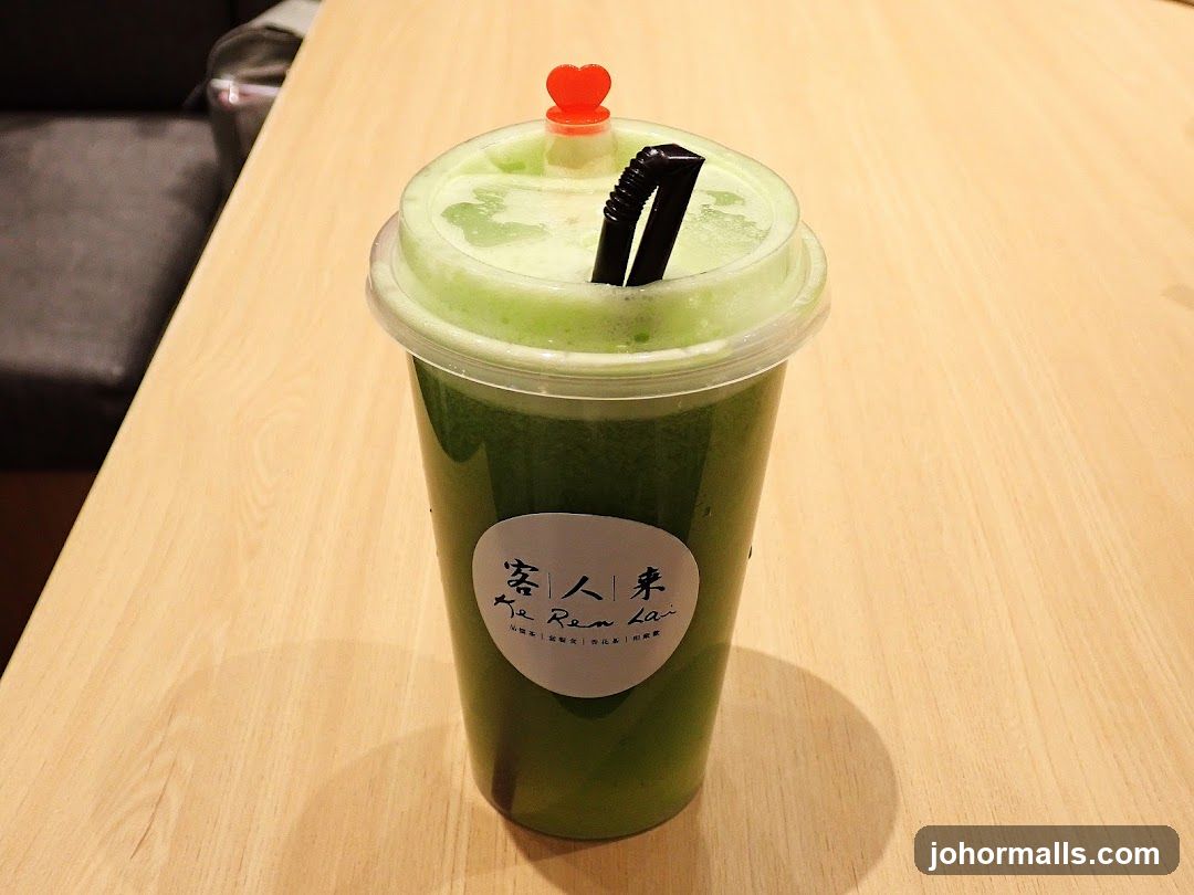Green beverage in plastic cup