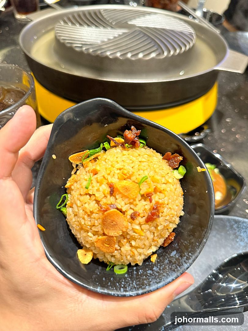 Hand holding fried rice dish