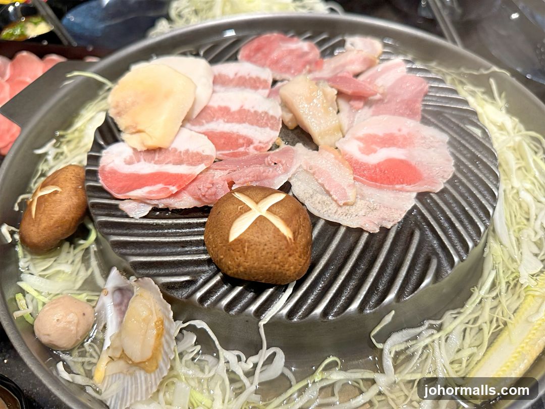 Grilled meat and vegetables on a hot plate