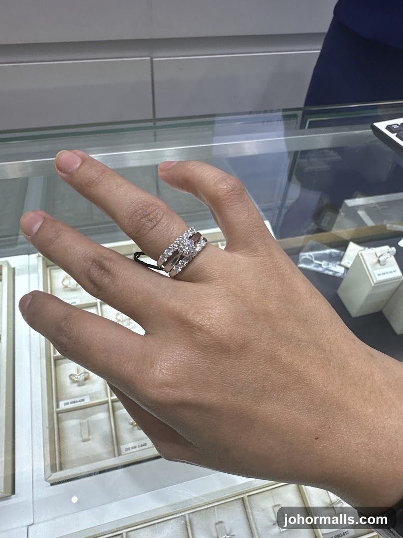 Hand wearing rings in jewelry display