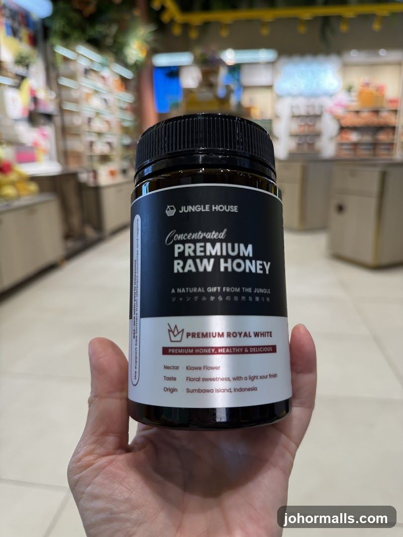 Hand holding honey jar in store