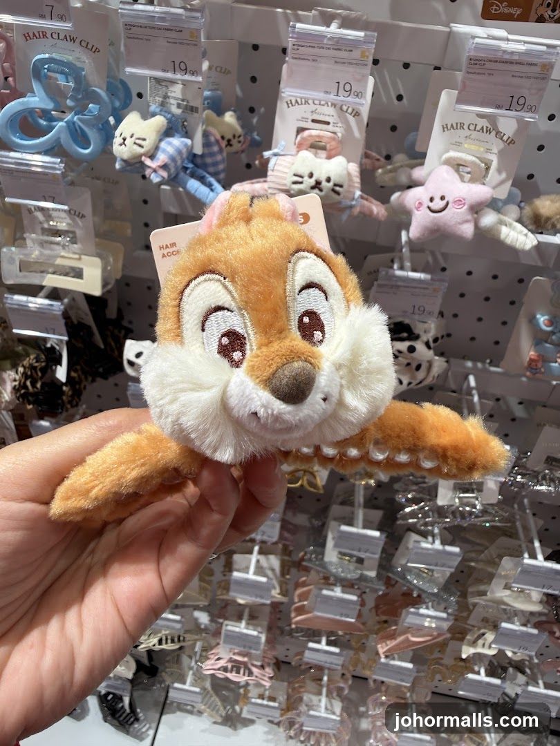 Hand holding Disney-themed hair clip