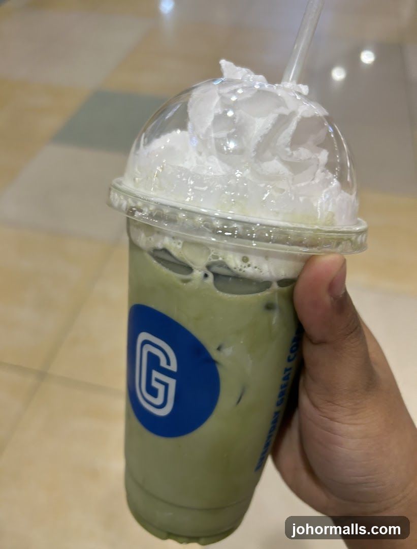 Hand holding iced beverage