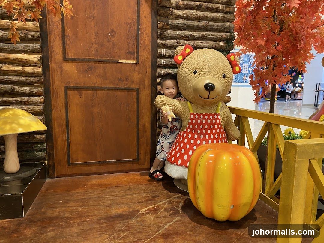 Child with bear statue in themed indoor area
