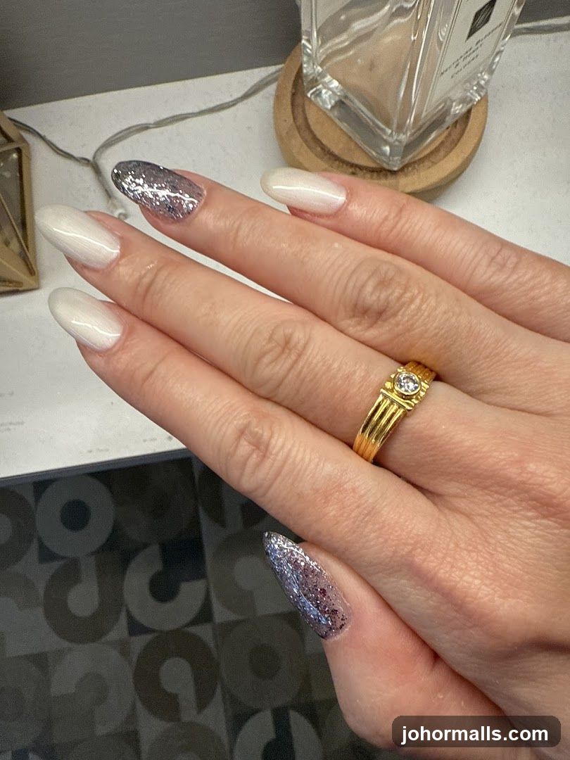 Woman's Hand with Glitter and White Nails