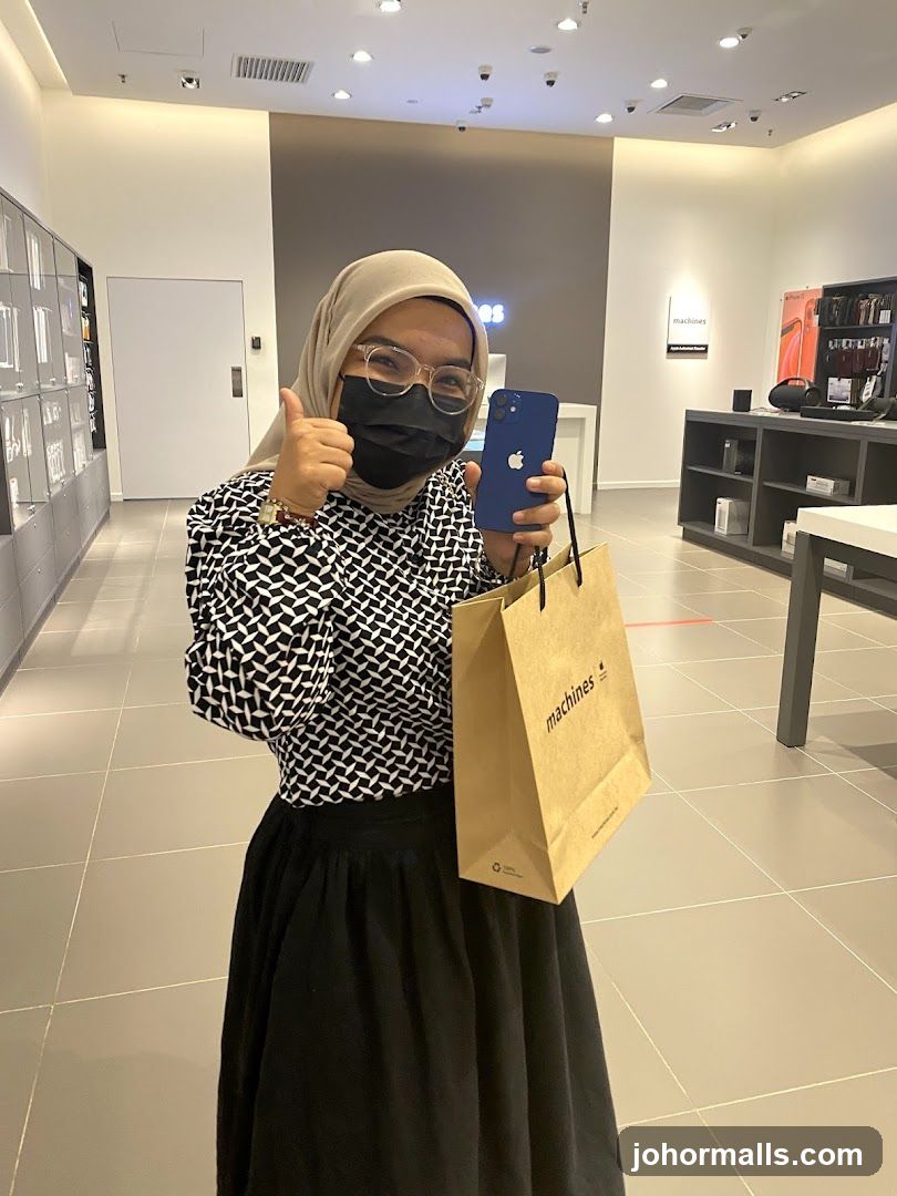 Woman holding a new iPhone and shopping bag