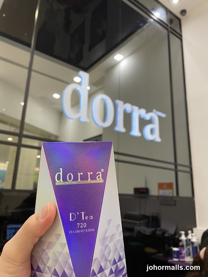 Hand holding Dorra tea box in front of store entrance